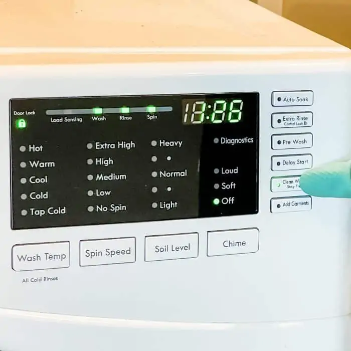 selecting "clean washer" setting on washing machine