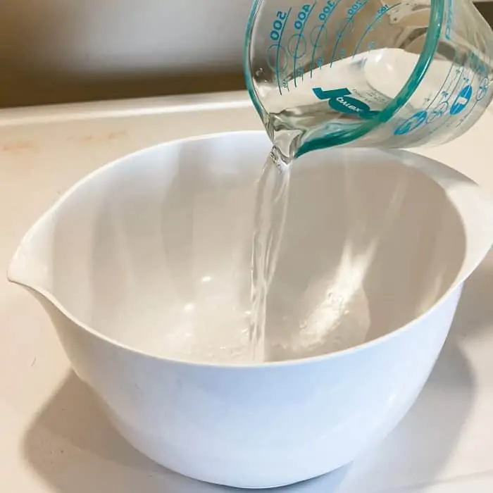 pouring hot water into bowl to make cleaner