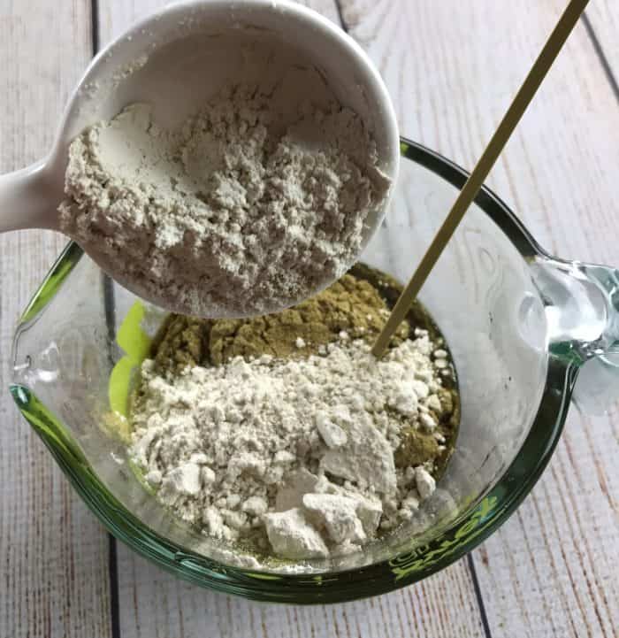 adding colloidal oatmeal to melted beeswax and oils