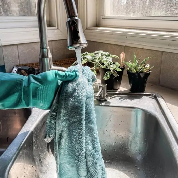 rinsing towel in kitchen sink
