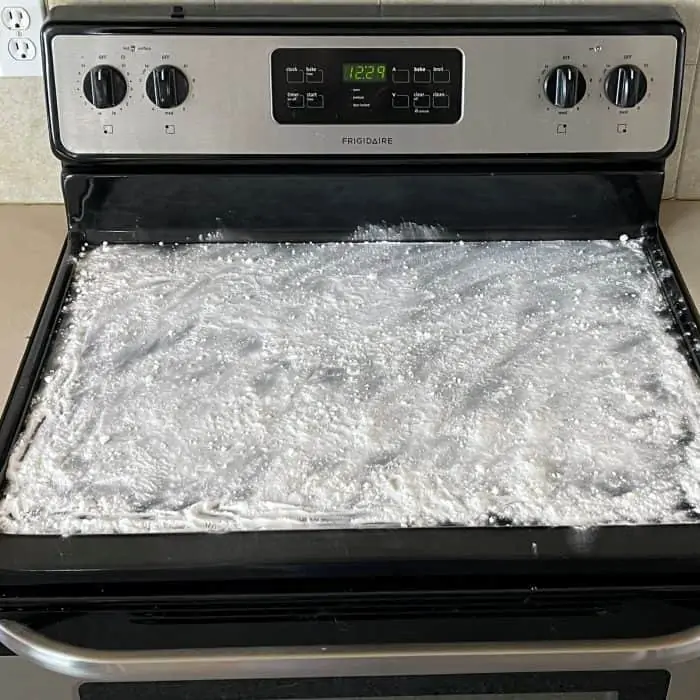 baking soda and essential oil mixture sprinkled evenly over cooktop