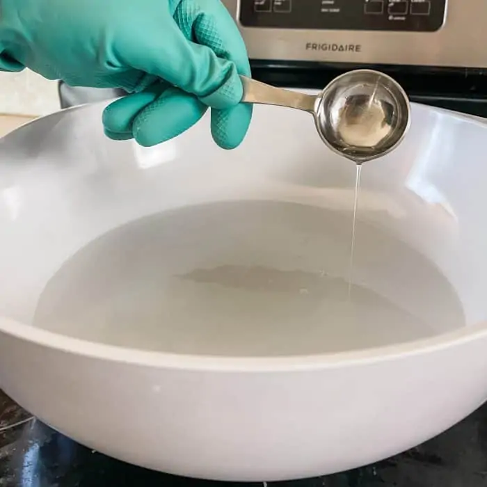 adding dish soap or liquid Castile soap to hot water