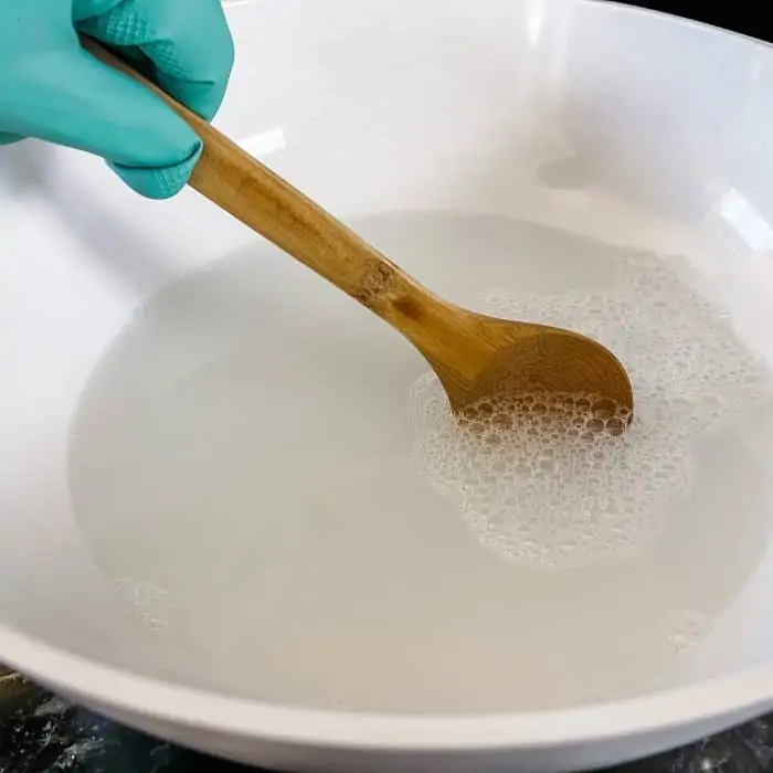 stirring hot water and dish soap