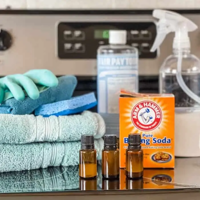 supplies used to naturally clean glass stovetop= towels, glove, sponge, essential oil, baking soda, Castile soap, and spray bottle