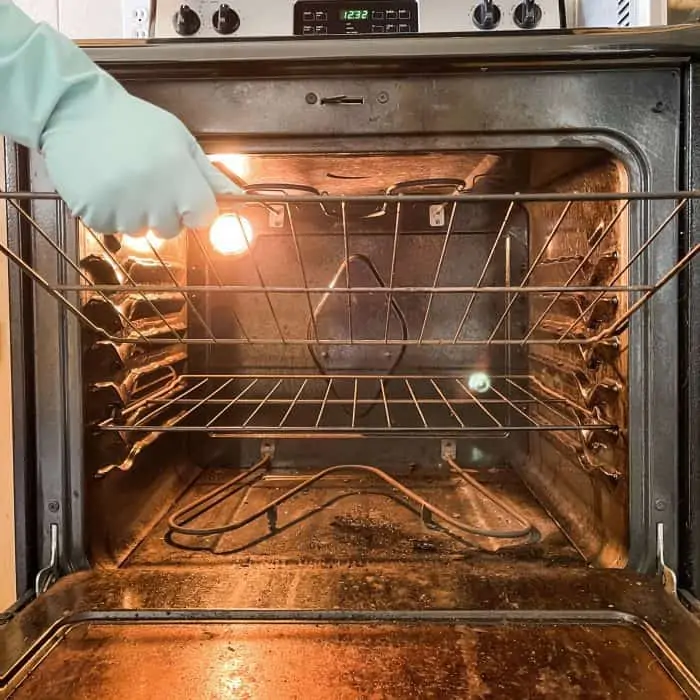 removing oven racks in prep for cleaning oven