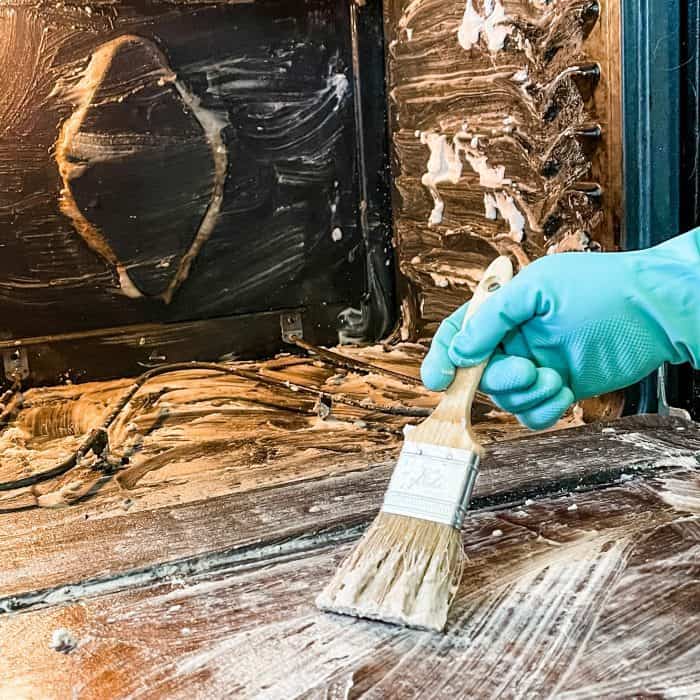 brush cleaning paste on oven door