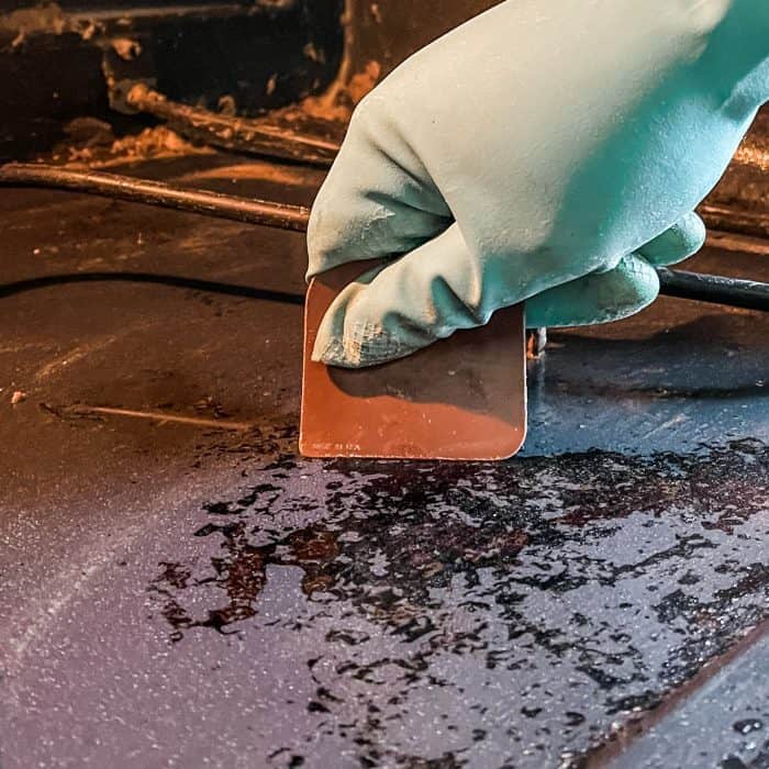 use a plastic scrapper (or razor blade) to scrape any stubborn bits of burnt on food from oven