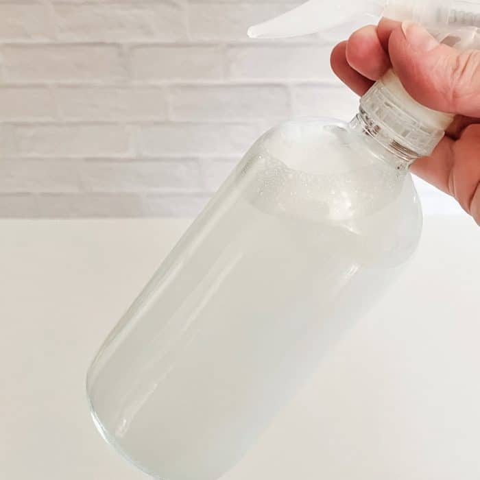 swirling mixture in spray bottle to mix it