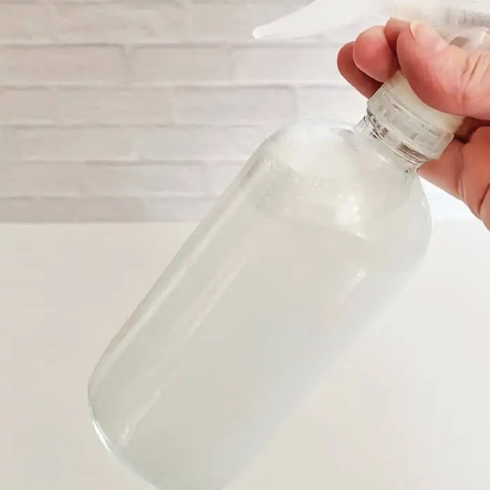 swirling mixture in spray bottle to mix it
