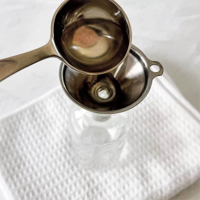 adding 2 tablespoons witch hazel to 4 oz glass spray bottle