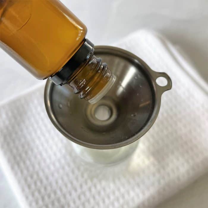 adding essential oil to spray bottle
