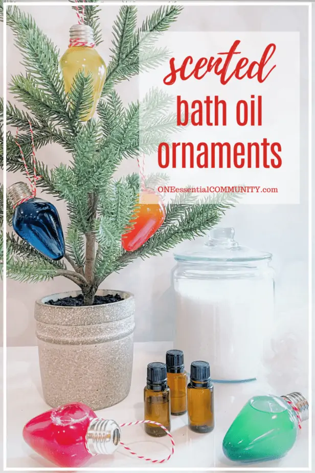 Scented bath oil ornaments by oneessentialcommunity.com -- 3 essential oil bottles by bath oil ornaments -- in front of tabletop Christmas tree and jar of bath salts