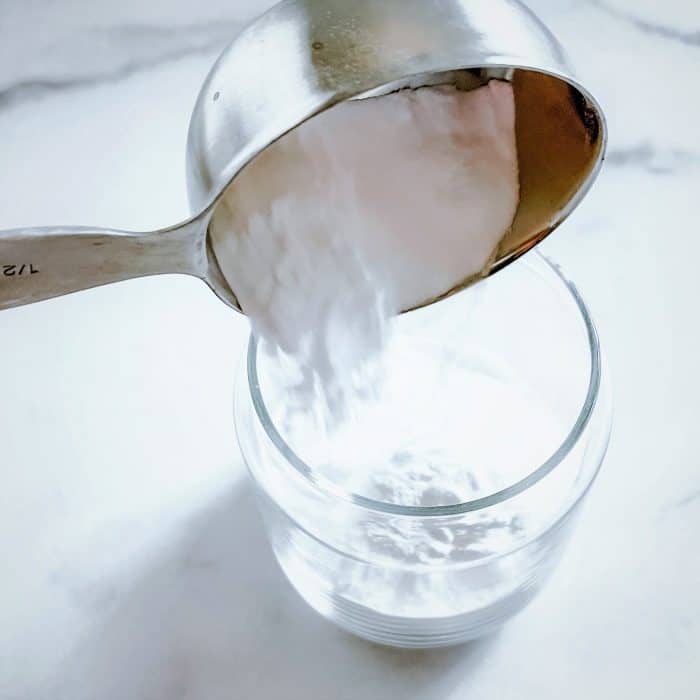adding baking soda to glass jar
