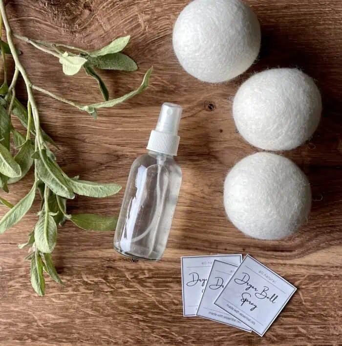 3 wool dryer balls, glass spray bottle, and free printable labels for homemade dryer ball spray