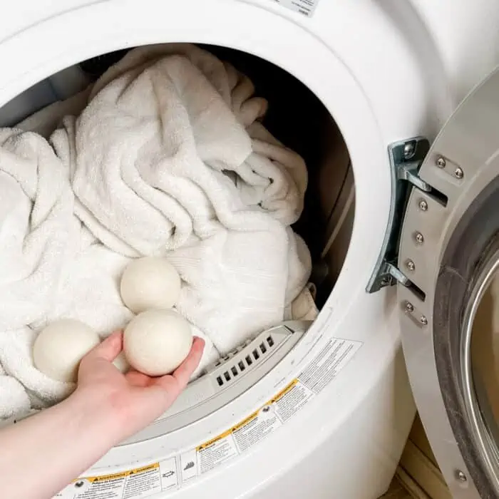 adding 3 dryer balls to dryer with laundry