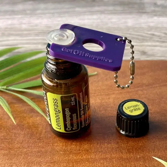 using essential oil bottle opener tool to remove drop reducer orifice from lemongrass essential oil bottle