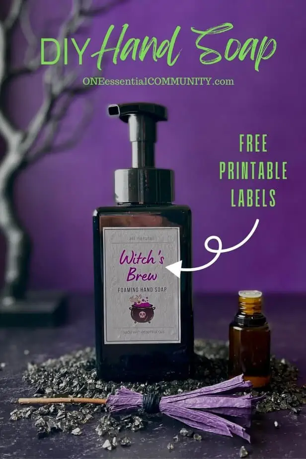 DIY Hand Soap free printable labels by oneessentialcommunity.com -- witch's Brew Halloween soap with mini witch's broom and essential oil bottle in front of haunted black tree