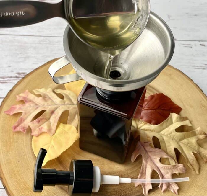 pouring liquid Castile soap into foaming soap bottle using funnel