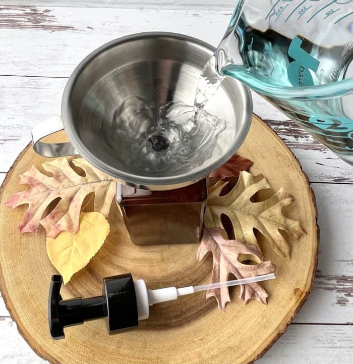 adding water to foaming soap mixture