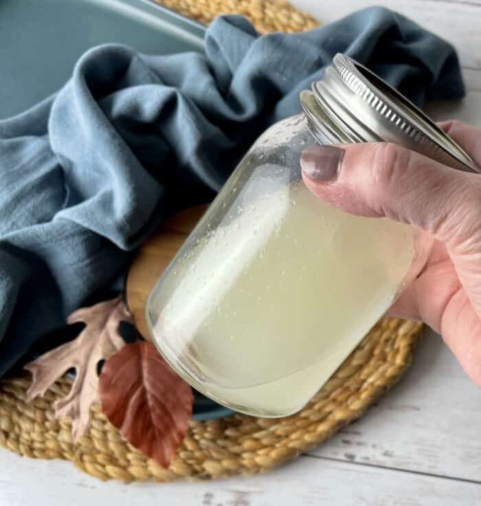 shaking up homemade reed diffuser liquid in mason jar