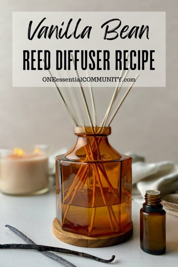 vanilla bean reed diffuser recipe by oneessentialcommunity.com -- vanilla beans, essential oil bottle, and lit vanilla candle around amber glass reed diffuser