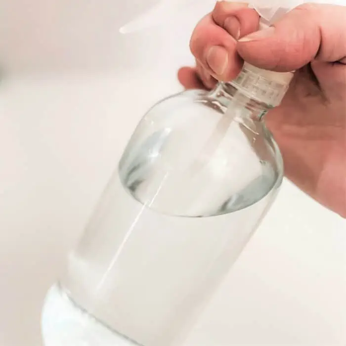 swirling bottle to mix water and baking soda together