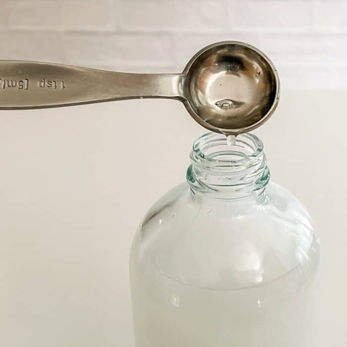 adding Castile soap to spray bottle